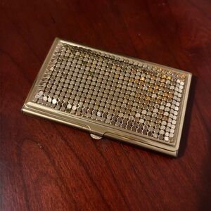 On Hold/ Gold mesh card holder. 
Or cigarette compact?